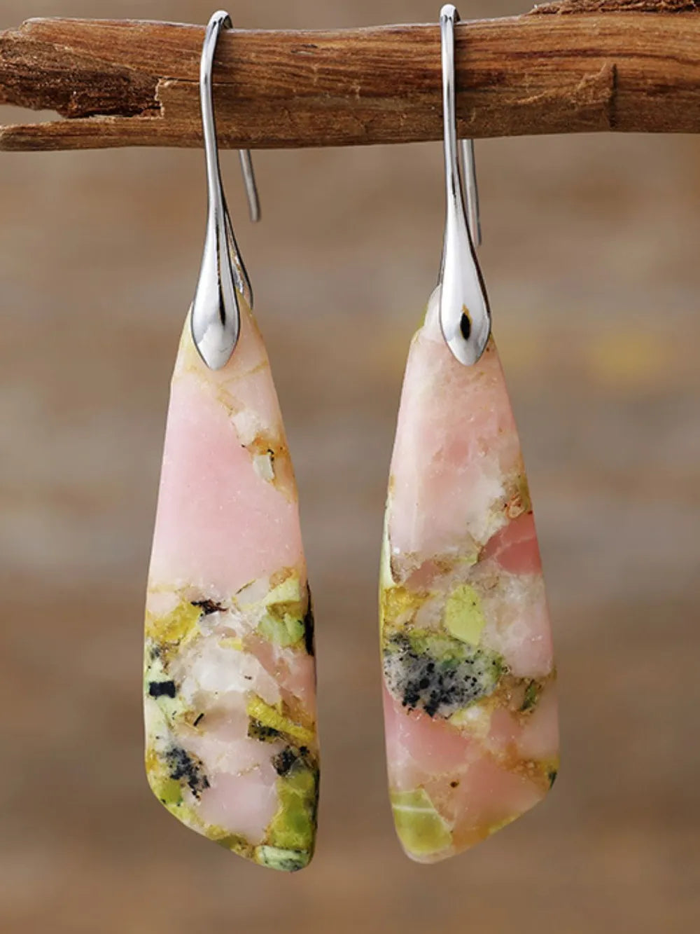 Pink teardrop earrings with gold-tone accents and natural stone inlay.