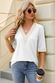 White textured v-neck blouse with lace trim on neckline and sleeves