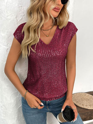 Crimson sequined cap-sleeve V-neck blouse with allover shimmer.