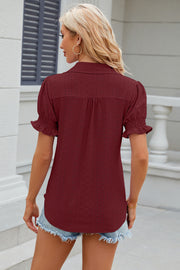 Burgundy eyelet polo blouse with short puff sleeves and ruffled cuffs.