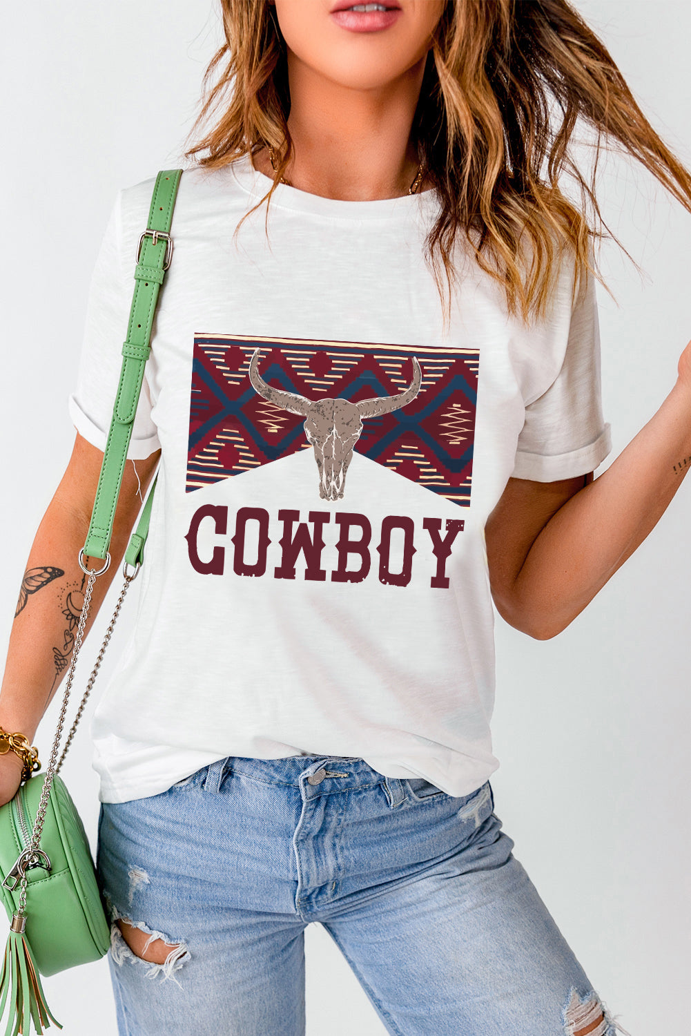 White t-shirt with cowboy skull graphic and geometric pattern, short sleeves