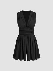 Black ruched deep V-neck romper with cinched waist and a-line shorts.