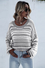 Cropped knit crew neck sweater with horizontal black and white stripes and grey neckline.
