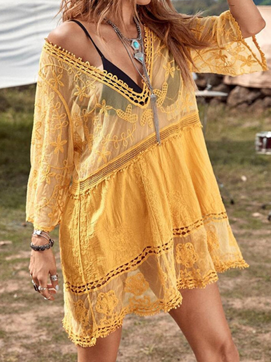 Yellow lace tiered mini dress with crochet trim and bell sleeves.