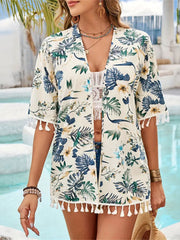 Tropical print kimono in pastel yellow with tassel trim and short sleeves.