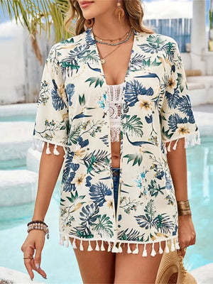 Tropical print kimono in pastel yellow with tassel trim and short sleeves.
