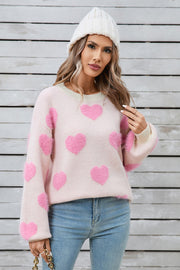 Blush pink fluffy knit sweater with allover pink hearts and balloon sleeves.