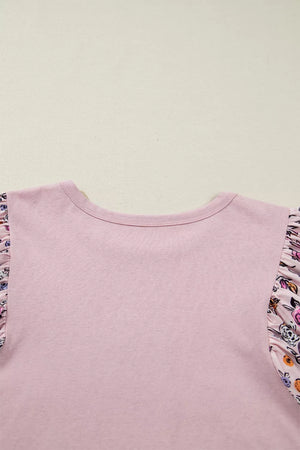 Maternity crew neck shirt in pink cotton with ruffled floral patchwork sleeves.