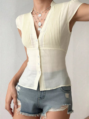 Cream V-neck cap sleeve maternity overshirt with button front and subtle pleating.