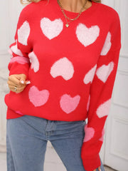 Red fuzzy knit sweater with white and pink heart pattern.
