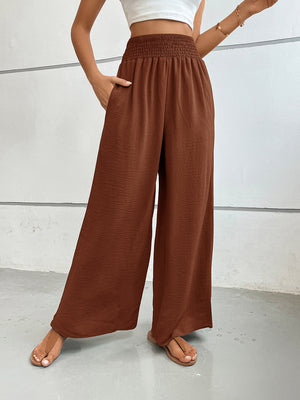 Textured palazzo lounge trousers in rust with smocked waist and wide legs.