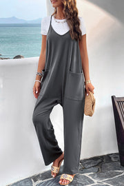 Dark Gray Relaxed Drape Pocket Jumpsuit with V-neck and wide legs, layered over a white tee.