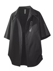Black oversized button-front shirt with short sleeves and a zipper pocket detail.