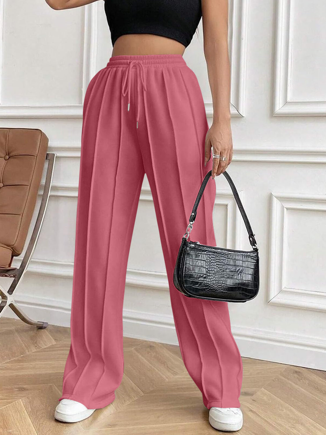 Dusty pink pleated palazzo drawstring trousers with a wide leg and a casual fit.