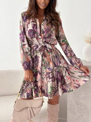 Delicate floral tie-waist mini dress with button-down front and tiered skirt.
