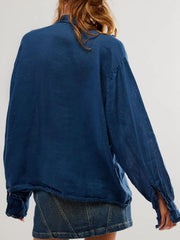Dark blue linen button-down blouse with ruffled cuffs and split sleeves.
