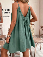 Turquoise cotton mini dress with spaghetti straps and a back tie detail.