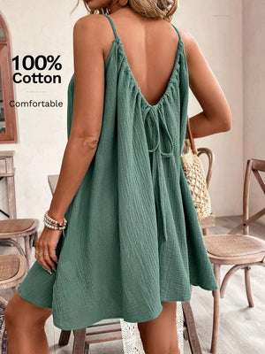 Turquoise cotton mini dress with spaghetti straps and a back tie detail.