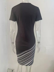 Black bodycon mini dress with geometric print detail on the hem.
