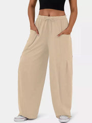 Tan wide-leg jeggings with drawstring waist and cargo pockets.
