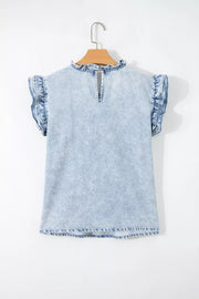Light wash denim blouse with ruffled cap sleeves and mock neckline.