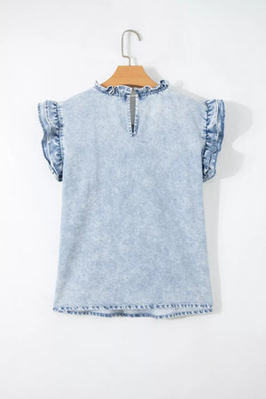Light wash denim blouse with ruffled cap sleeves and mock neckline.