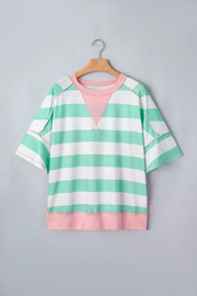 Oversized t-shirt with green and white stripes, pink neckline and hem, and exposed seams.