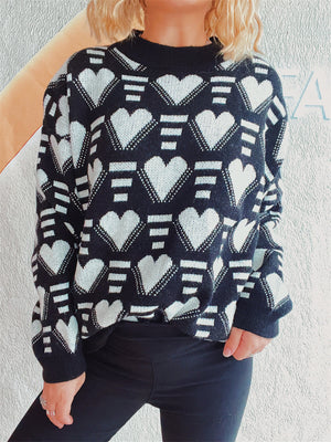 Black acrylic knit jumper with allover white geometric heart pattern and mock neck.