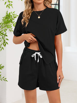 Black relaxed two-piece set with crew neck tee and drawstring shorts with pockets.