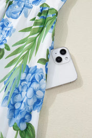 Ruffled mini dress with hydrangea and palm print, featuring a white background and blue floral pattern.