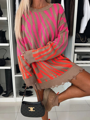 Distressed zebra stripe knit tunic sweater with crewneck and frayed hem.