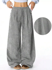 Gray corduroy maternity trousers with wide legs and drawstring waist.