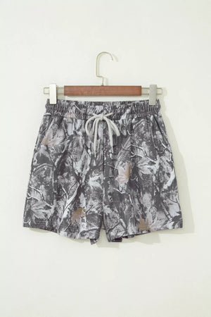 Chino shorts with abstract maple leaf print, elastic waist and drawstring.