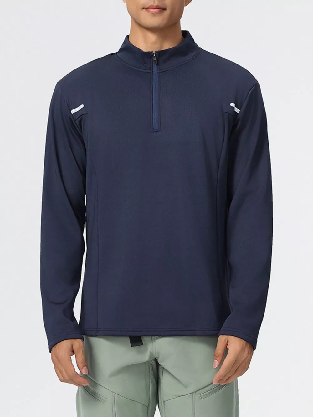 Men's dark navy half-zip sweatshirt with reflective shoulder details.