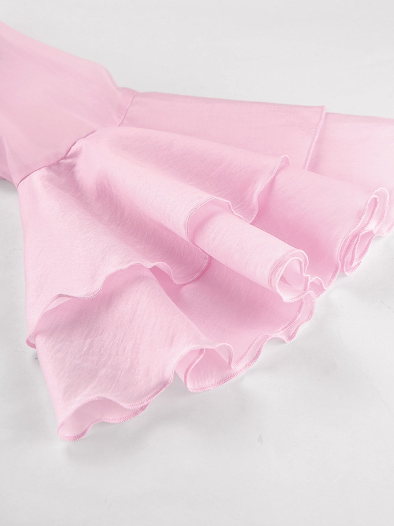 Blush pink ruffle trim long sleeve blouse with dramatic sleeves and ruffled cuffs.