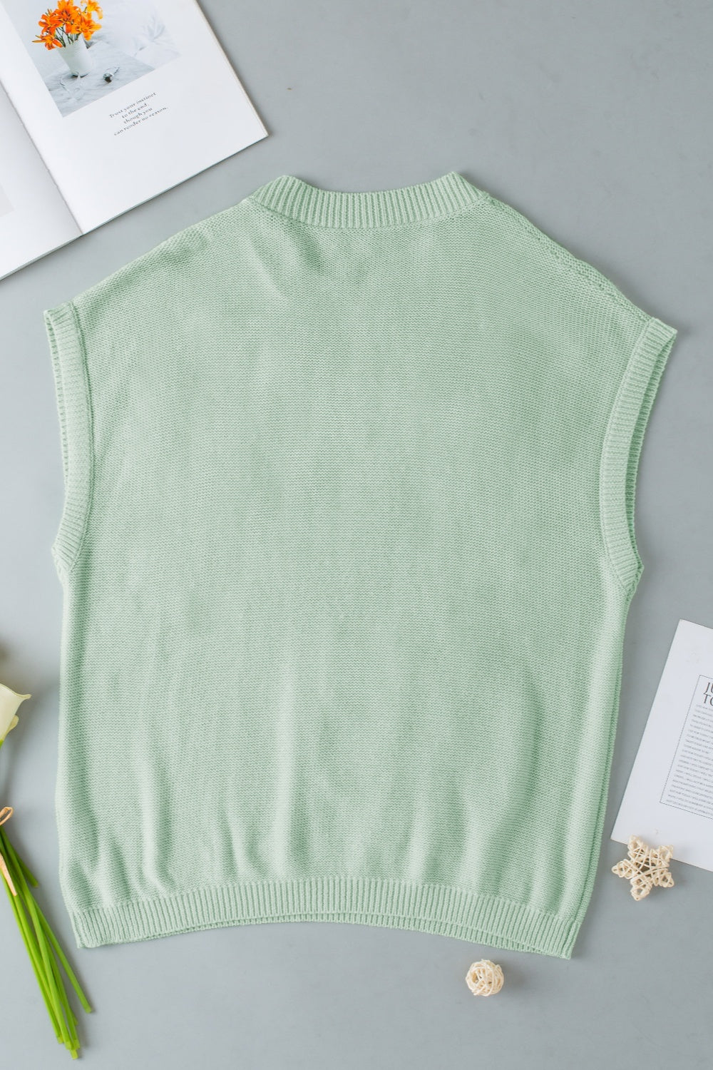 Sage knit sleeveless top with mock neck and ribbed trim.