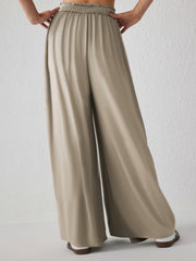 Khaki jersey wide-leg trousers with a smocked waistband and a drape front.