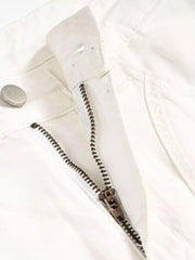 White sweatpants with zipper fly and button closure detail.