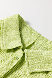 Lime textured collared romper with button detail and patch pocket.