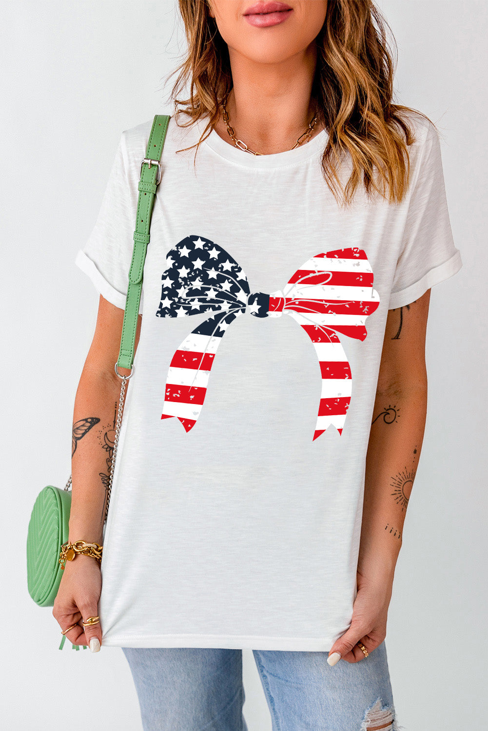 White t-shirt with distressed American flag bow graphic, crew neck, short sleeves.