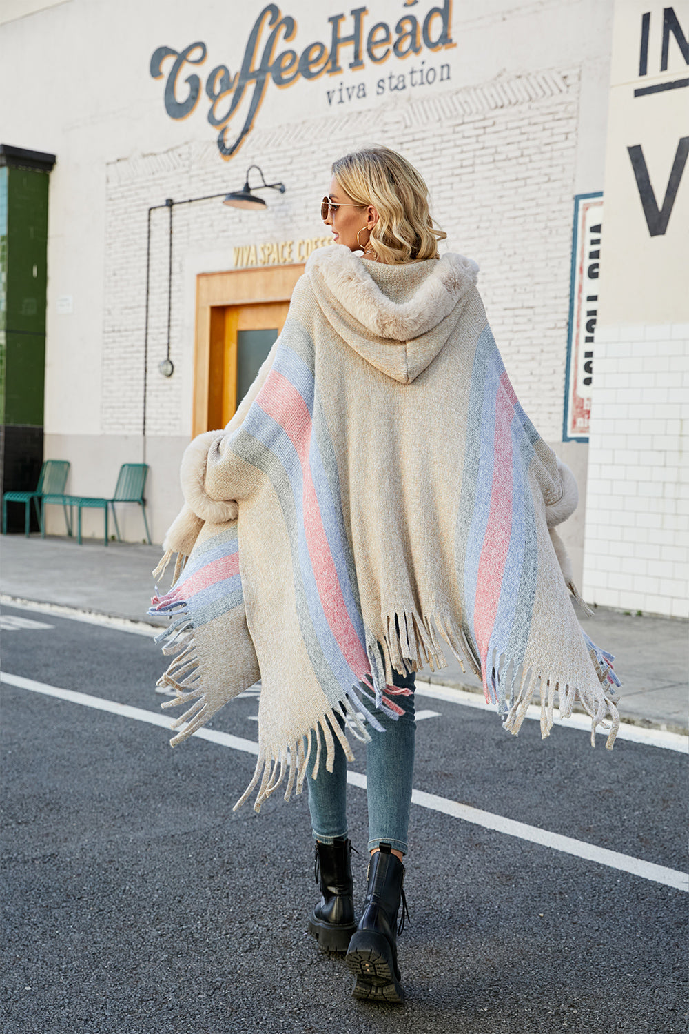 Textured stripe faux fur trim poncho with fringe detail and hood.