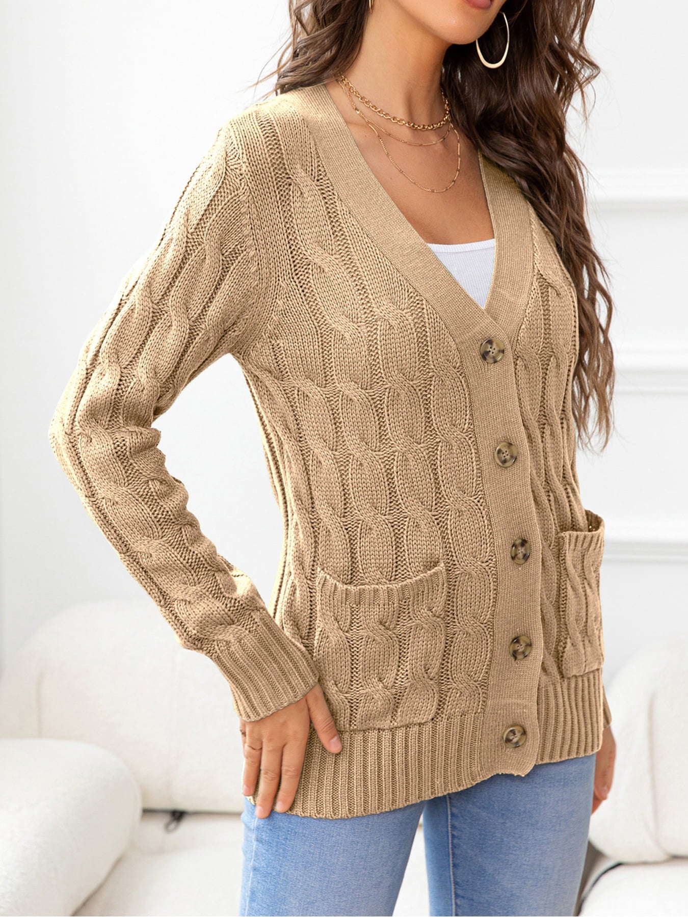 Camel cable-knit cardigan with v-neck, buttons, and pockets.