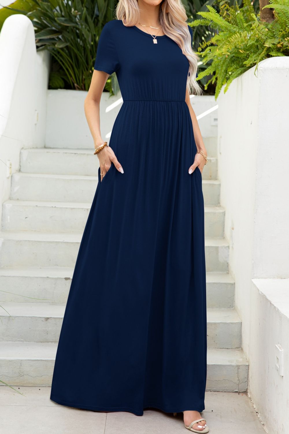Navy gathered waist maxi dress with pockets and short sleeves.