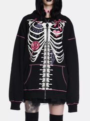 Black zip-up hoodie with playful skeleton graphic, pink stitching, and drawstring hood.