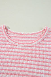 Textured stripe blouse in blush pink with a round neckline.