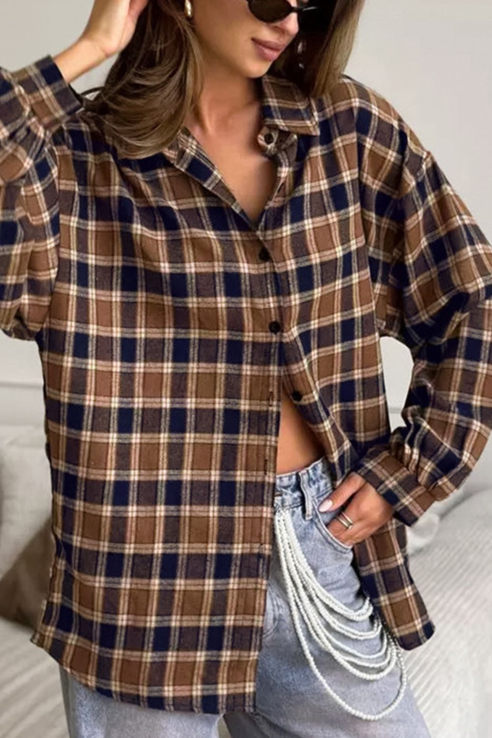 Oversized brown plaid button-up shirt jacket with a collared neckline and buttoned front.