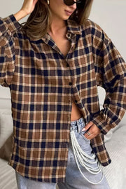 Oversized brown plaid button-up shirt jacket with a collared neckline and buttoned front.