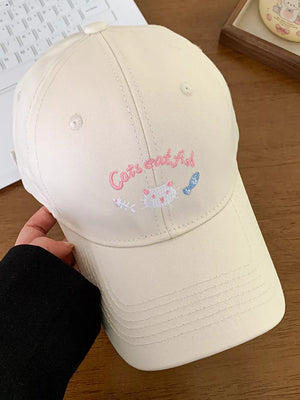 Off-white baseball cap with cat and fish embroidery and "Cats eat fish" text.