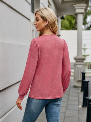Plunge neckline gathered sleeve top in strawberry heather, styled with jeans.