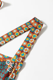 Floral patchwork culotte jumpsuit with geometric and floral prints.